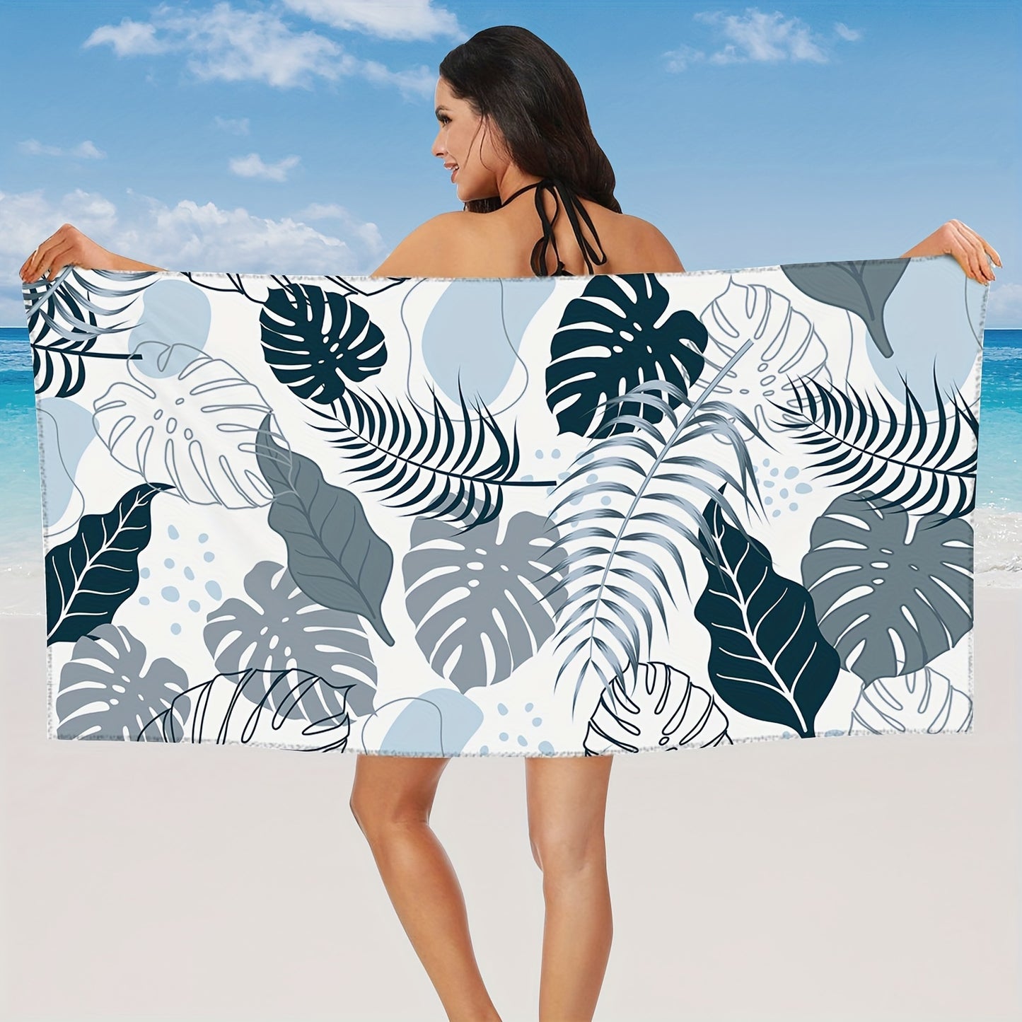 Tropical leaves in different shades of blue on beach bath towel